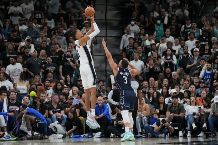 Oct 25, 2023; San Antonio, Texas, USA; San Antonio Spurs center Victor Wembanyama (1) shoots over Dallas Mavericks forward Grant Williams (3) in the second half at the Frost Bank Center.